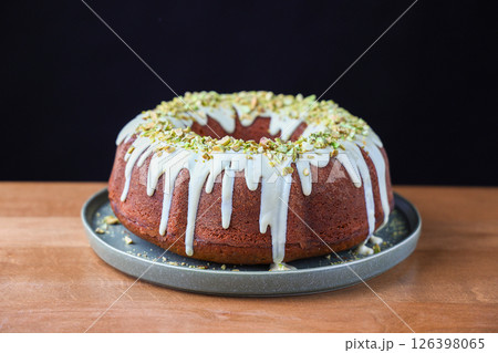 Pistachio Bundt Cake with White Chocolate Glaze on Plate Pistachio Bundt Cake with White Chocolate Glaze on Plate 126398065