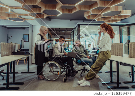 Young group of business people brainstorming together in a startup space, discussing business projects, investments, and solving challenges. 126399477