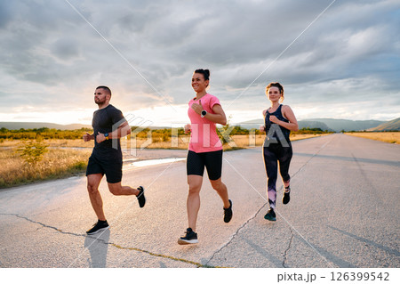 Athlete Leading Group Run at Sunset Amidst Stunning Nature 126399542