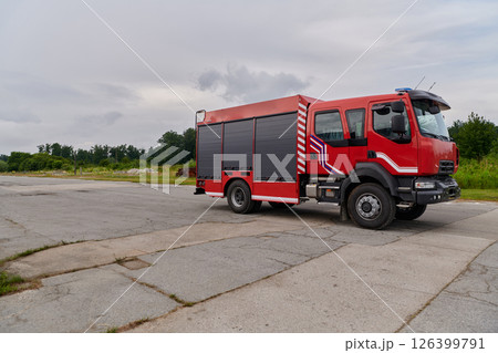 In this captivating scene, a state-of-the-art firetruck, equipped with advanced rescue technology, stands ready with its skilled firefighting team, prepared to intervene and respond rapidly to In this captivating scene, a state-of-the-art firetruck, equipped with advanced rescue technology, stands ready with its skilled firefighting team, prepared to intervene and respond rapidly to 126399791