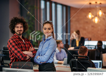 Corporate Collaboration: European Blonde Businesswoman and Colleague Standing in Modern Office Corporate Collaboration: European Blonde Businesswoman and Colleague Standing in Modern Office 126399847