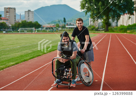 A cameraman filming the participants of the Paralympic race on the marathon course 126399888
