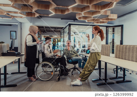Young group of business people brainstorming together in a startup space, discussing business projects, investments, and solving challenges. 126399992