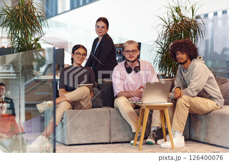 In a modern startup office, a diverse group of young professionals collaboratively tackles various business problems and challenges, surrounded by their engaged colleagues, fostering innovation and 126400076