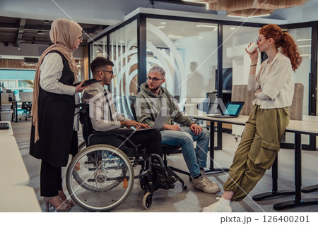 Young group of business people brainstorming together in a startup space, discussing business projects, investments, and solving challenges. 126400201