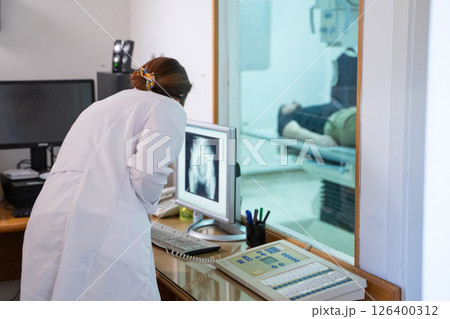 Radiologist Analyzing X-Ray Scans in a Medical Imaging Room. 126400312