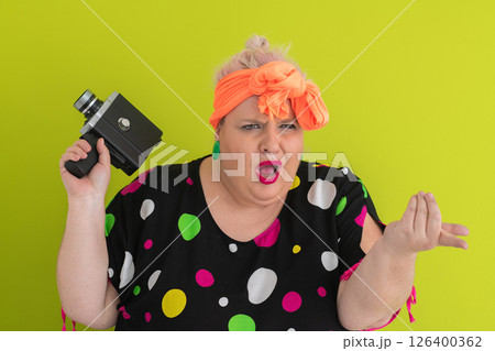 Colorful Woman Holding Vintage Camera in Quirky Studio Portrait 126400362