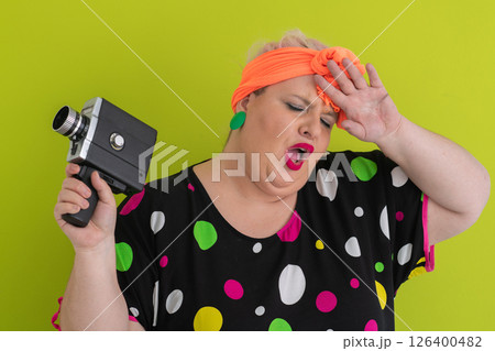 Colorful Woman Holding Vintage Camera in Quirky Studio Portrait 126400482