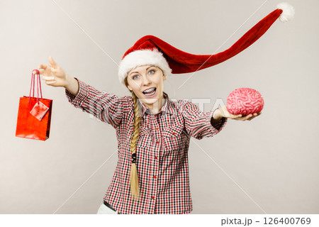 Christmas woman holding shopping bag and brain Christmas woman holding shopping bag and brain 126400769