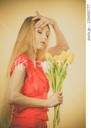 Pretty woman with yellow tulips bunch Pretty woman with yellow tulips bunch 126400777