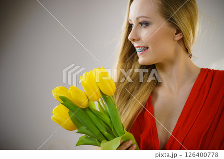 Pretty woman with yellow tulips bunch Pretty woman with yellow tulips bunch 126400778
