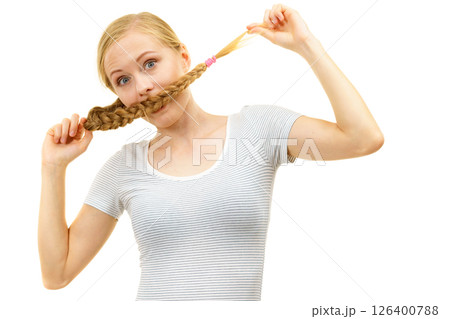 Blonde girl covering her mouth with braid hair 126400788