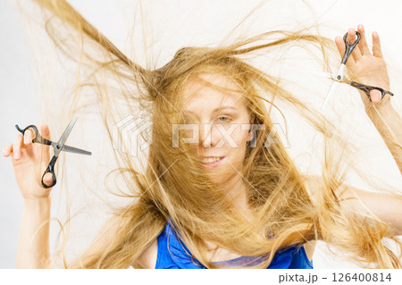 Girl with scissors for haircutting 126400814