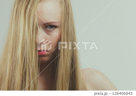 Sad girl covers her face with long hair 126400843