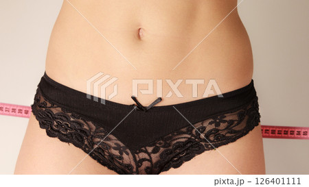 Woman measuring her hips closeup Woman measuring her hips closeup 126401111