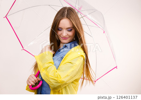 Woman wearing waterproof coat under umbrella Woman wearing waterproof coat under umbrella 126401137