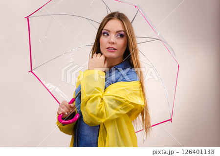 Woman wearing waterproof coat holding umbrella 126401138