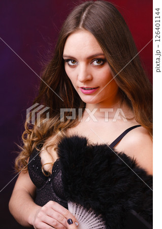 Woman holding carnival feather fan in hand. Woman holding carnival feather fan in hand. 126401144