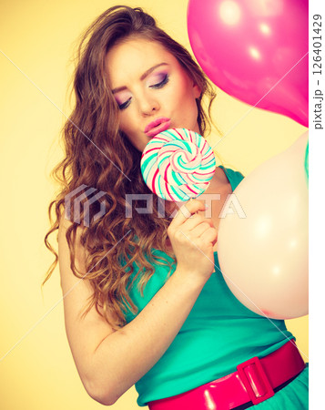 Woman with colorful balloons and lollipop 126401429