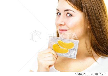 Woman ready to apply gold eye patches 126401575