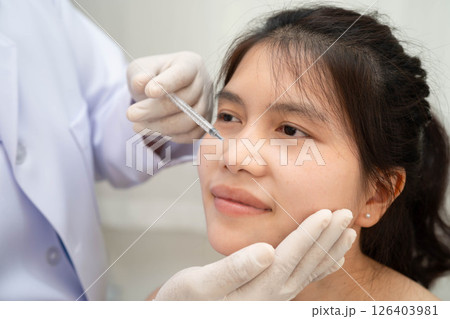 Asian woman receiving botox filler beauty injection. 126403981