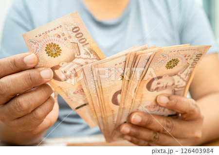Asian woman counting Thai baht banknote money, investment economy, accounting business and banking. 126403984