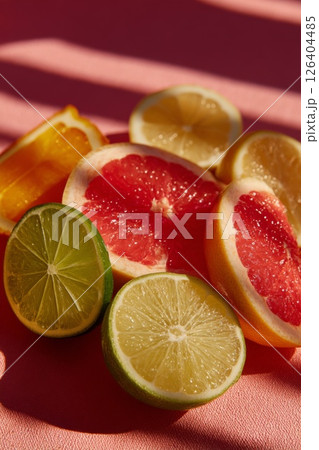 Vibrant Citrus Fruit Slices on Pink Background 126404485