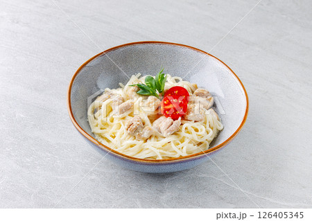 Creamy Chicken Pasta with Cherry Tomato Garnish in Ceramic Bowl Creamy Chicken Pasta with Cherry Tomato Garnish in Ceramic Bowl 126405345