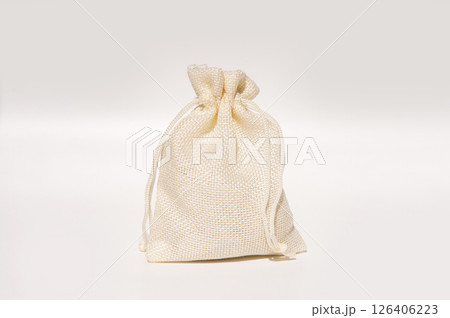 Beige burlap drawstring bag on white background 126406223