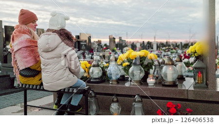 A group of children thoughtfully reflecting in a serene cemetery during the autumn season A group of children thoughtfully reflecting in a serene cemetery during the autumn season 126406538