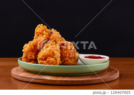 Crispy Fried Chicken Drumsticks with Sweet Chili Dip on Green Plate 126407005
