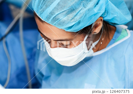 Female doctor performing a surgery. Surgery and insurance concept. Female doctor performing a surgery. Surgery and insurance concept. 126407375