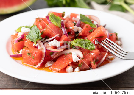 Fresh Watermelon Feta Salad with Mint and Red Onion on wooden table 126407653