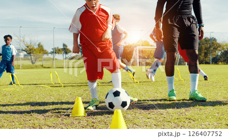Sports field, soccer player and children with ball, coach and athlete with energy for practice in morning. Playing, football and kids with sportswear for game, growth and development with fitness Sports field, soccer player and children with ball, coach and athlete with energy for practice in morning. Playing, football and kids with sportswear for game, growth and development with fitness 126407752