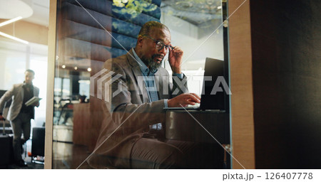 Laptop, planning and typing with business black man in pod for financial reporting. Computer, reading and research with mature African employee in cubicle of hotel lobby for accounting or finance Laptop, planning and typing with business black man in pod for financial reporting. Computer, reading and research with mature African employee in cubicle of hotel lobby for accounting or finance 126407778