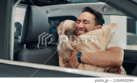 Excited, new car or couple in showroom with hug, smile or investment in auto insurance. Purchase, happy people or buyer in dealership shopping for vehicle finance, customer satisfaction or motor sale 126408094