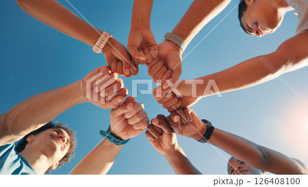 People, team and fist bump in fitness with blue sky below for motivation, unity or mission. Low angle, group or friends with hands together in huddle, circle or solidarity for health and wellness People, team and fist bump in fitness with blue sky below for motivation, unity or mission. Low angle, group or friends with hands together in huddle, circle or solidarity for health and wellness 126408100