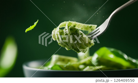 Spinach-infused pasta coated in a velvety basil pesto sauce Spinach-infused pasta coated in a velvety basil pesto sauce 126409550