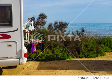 Camper on nature with clothes to dry on back rack 126410598