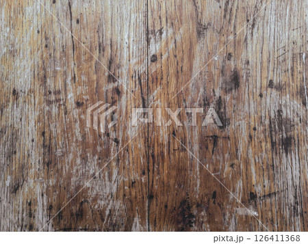 The image is of a wooden surface with a lot of scratches and marks 126411368
