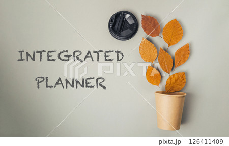 Leafy plant in a brown cup with the words Integrated Planner written below it 126411409