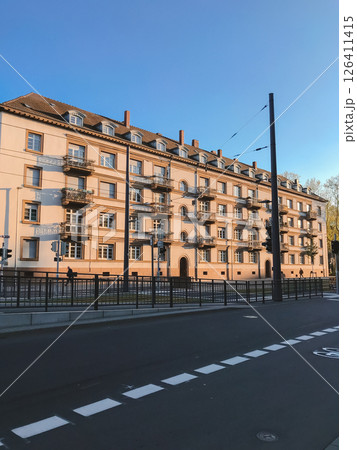 A large building with a lot of windows and balconies A large building with a lot of windows and balconies 126411415