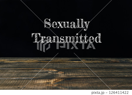 a wooden table with the words Sexually Transmitted a wooden table with the words Sexually Transmitted 126411422