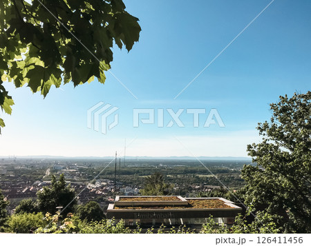 View of a city from a hilltop with a clear blue sky 126411456
