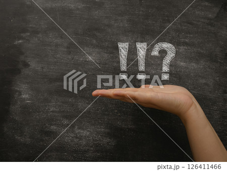Hand is holding a chalkboard with a question mark and an exclamation point Hand is holding a chalkboard with a question mark and an exclamation point 126411466