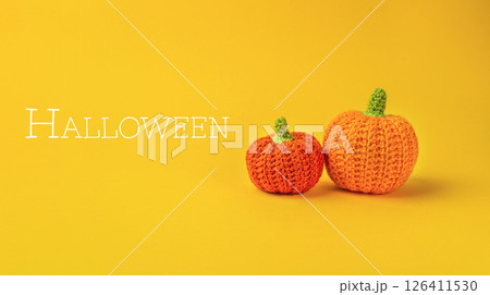 The image conveys a festive and playful mood, as the pumpkins are crocheted 126411530