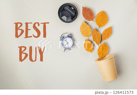 Clock and a cup of coffee are on a table with the words Best Buy Clock and a cup of coffee are on a table with the words Best Buy 126411573
