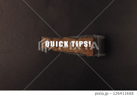 Piece of wood with the words quick tips written on it 126411688