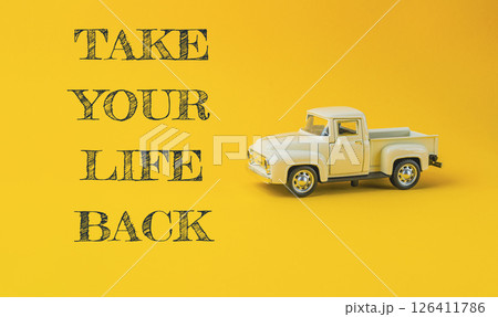Toy truck is on a yellow background with the words Take your life back 126411786