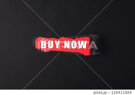 Buy now is written on a torn piece of paper Buy now is written on a torn piece of paper 126411984
